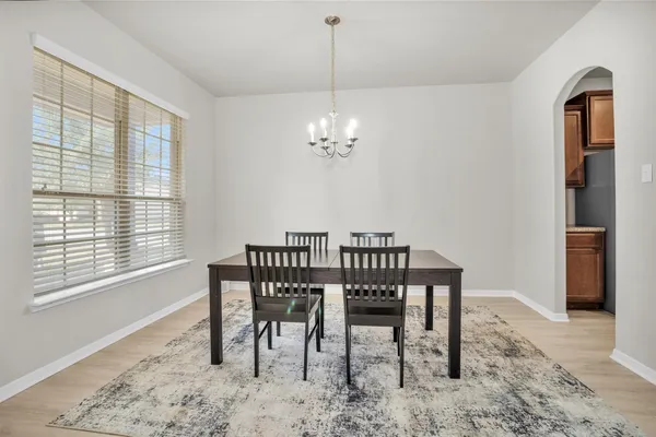a view of a dining room with furniture and window