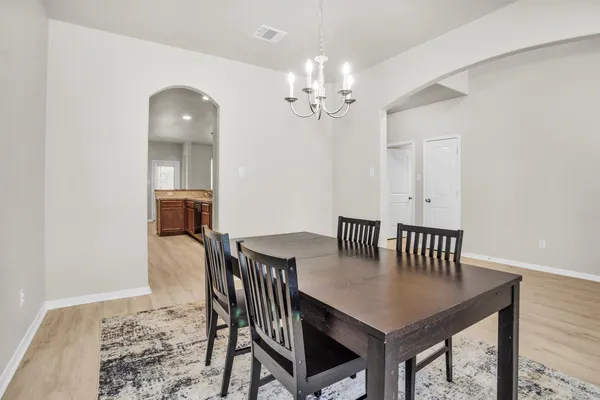 a view of a dining room with furniture and wooden floor