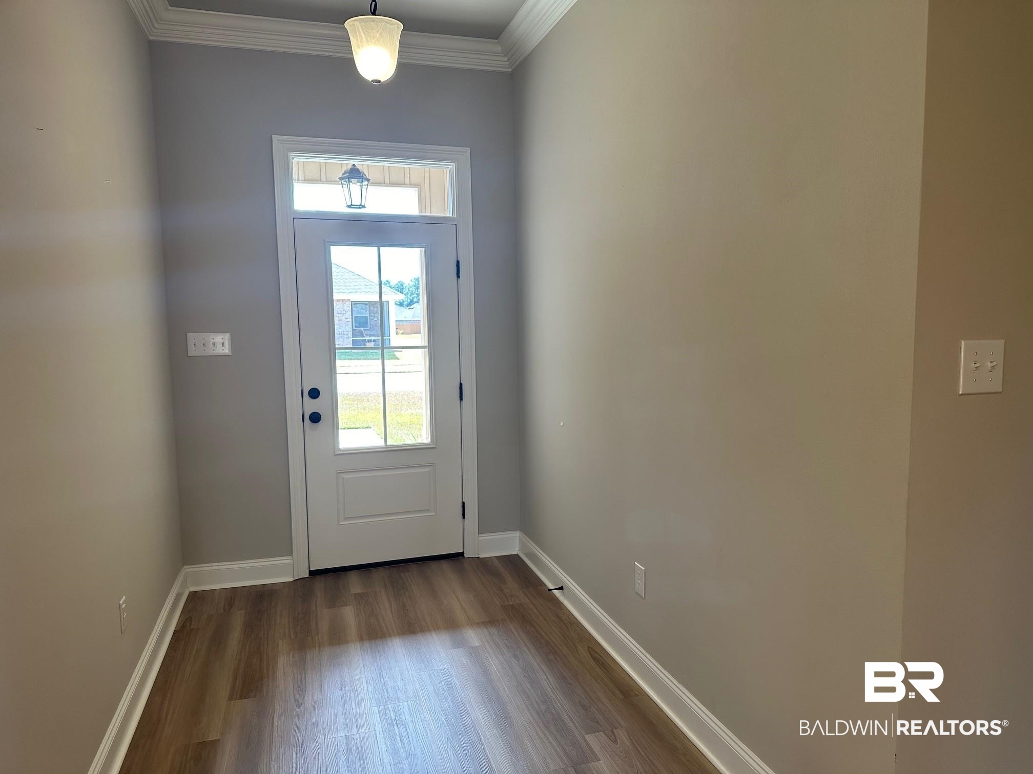 1009 Ruisseau Drive Foley, AL 36535 - Photo 12 of 55 Doorway with ornamental molding and wood-type flooring