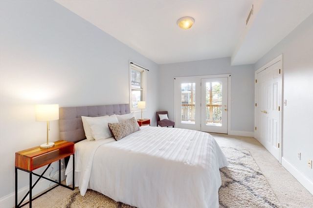 a bedroom with a large bed and a window