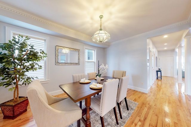 a view of a dining room with furniture wooden floor and chandelier