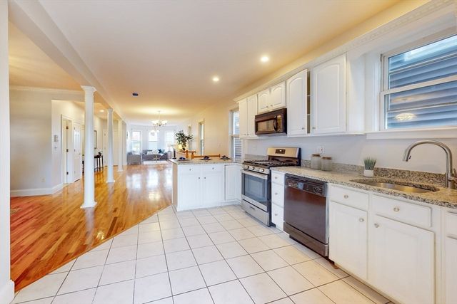 a kitchen with stainless steel appliances granite countertop a refrigerator and a stove top oven