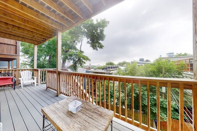 a view of balcony with wooden floor & fence