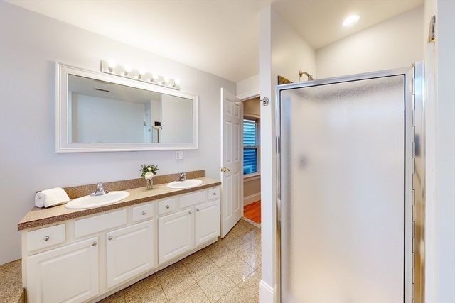 a bathroom with a double vanity sink mirror and