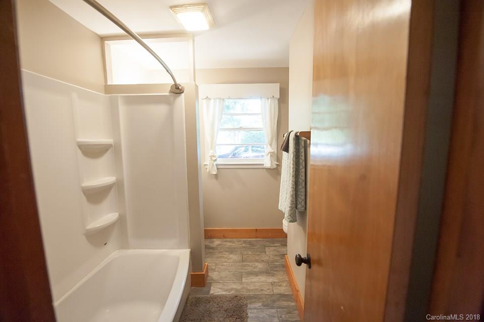 288 Deaverview Road, Unit B Asheville, NC 28806 - Photo 16 of 28 a bathroom with a bathtub and a shower