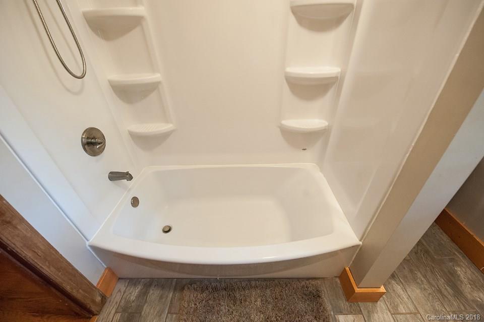 288 Deaverview Road, Unit B Asheville, NC 28806 - Photo 18 of 28 a bathroom with a bathtub and a toilet