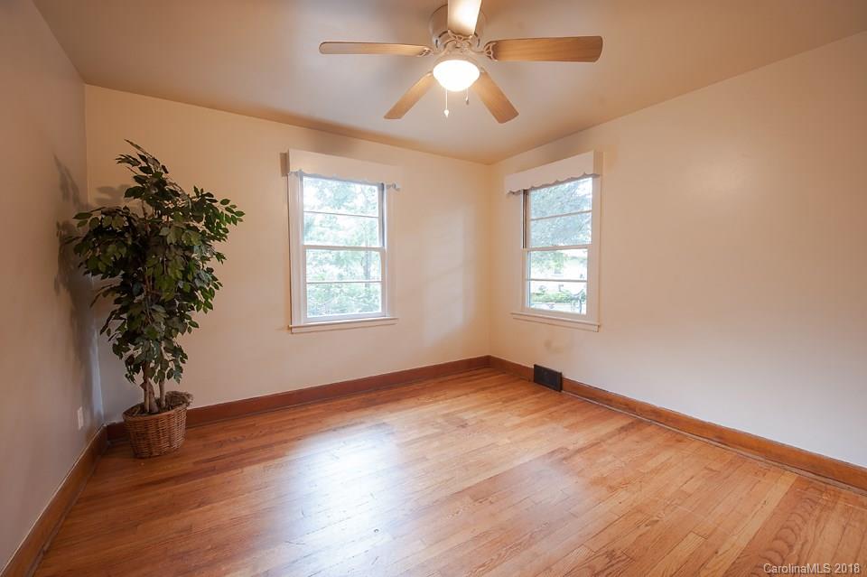 288 Deaverview Road, Unit B Asheville, NC 28806 - Photo 20 of 28 an empty room with wooden floor and windows