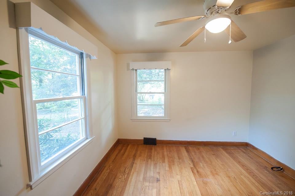 288 Deaverview Road, Unit B Asheville, NC 28806 - Photo 21 of 28 a view of an empty room with wooden floor and a window
