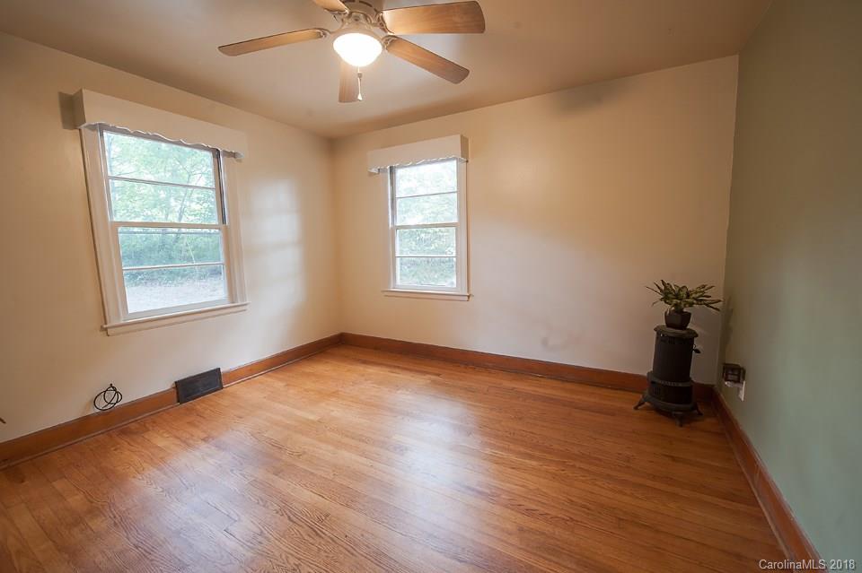 288 Deaverview Road, Unit B Asheville, NC 28806 - Photo 23 of 28 a view of an empty room with a window and wooden floor