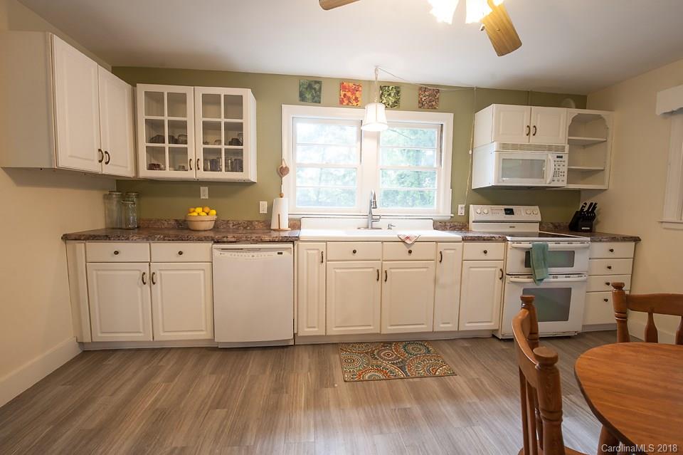 288 Deaverview Road, Unit B Asheville, NC 28806 - Photo 4 of 28 a kitchen with a sink window and cabinets
