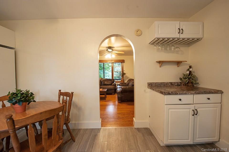 288 Deaverview Road, Unit B Asheville, NC 28806 - Photo 10 of 28 a view of a livingroom with furniture wooden floor a chandelier