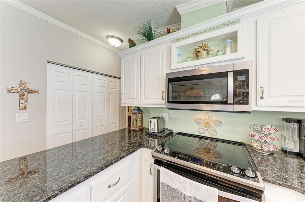 12507 Cortez Road West, Unit 35 Cortez, FL 34215 - Photo 16 of 36 a kitchen with a stove and cabinets