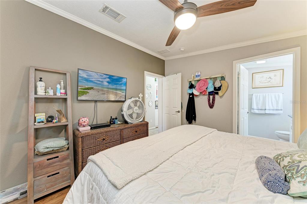 12507 Cortez Road West, Unit 35 Cortez, FL 34215 - Photo 19 of 36 a bedroom with a bed and a dresser