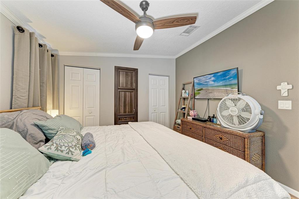 12507 Cortez Road West, Unit 35 Cortez, FL 34215 - Photo 20 of 36 a bedroom with a bed and a chandelier