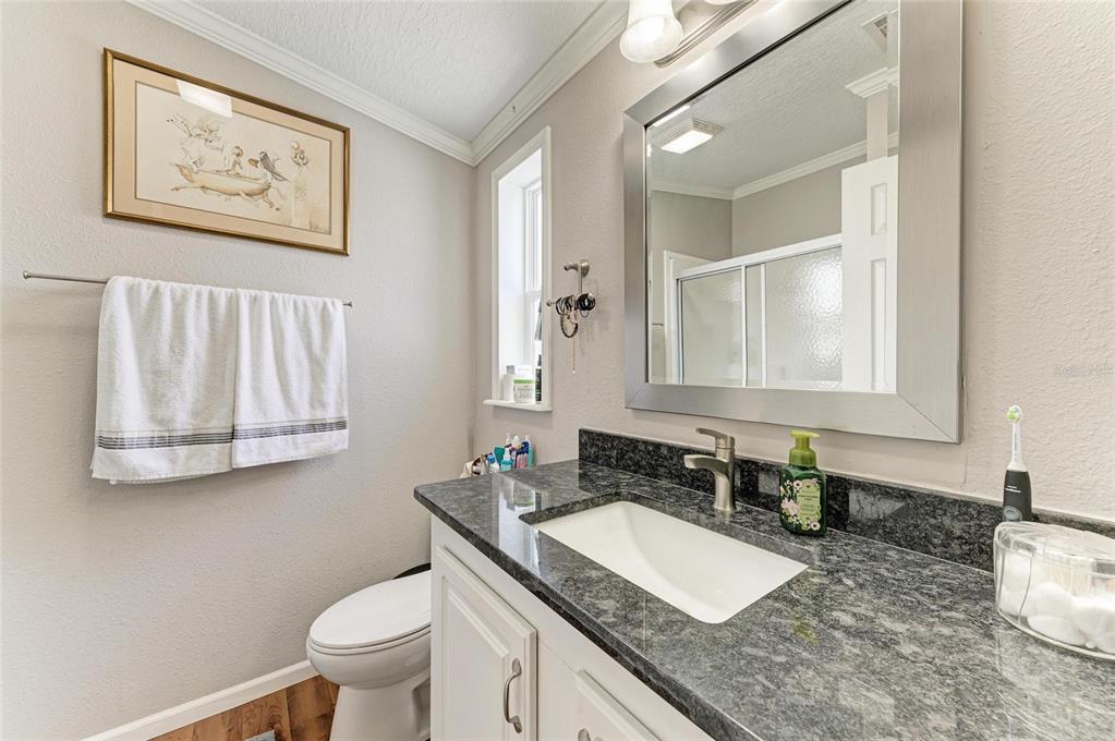 12507 Cortez Road West, Unit 35 Cortez, FL 34215 - Photo 21 of 36 a bathroom with a granite countertop sink and a mirror