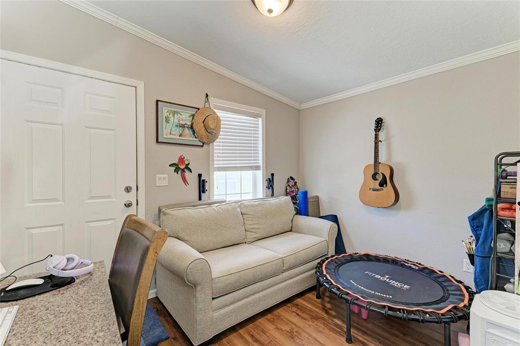 12507 Cortez Road West, Unit 35 Cortez, FL 34215 - Photo 23 of 36 a living room with furniture and a chair