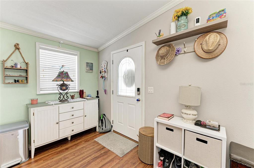 12507 Cortez Road West, Unit 35 Cortez, FL 34215 - Photo 7 of 36 a room with a wooden floor a clock and a window