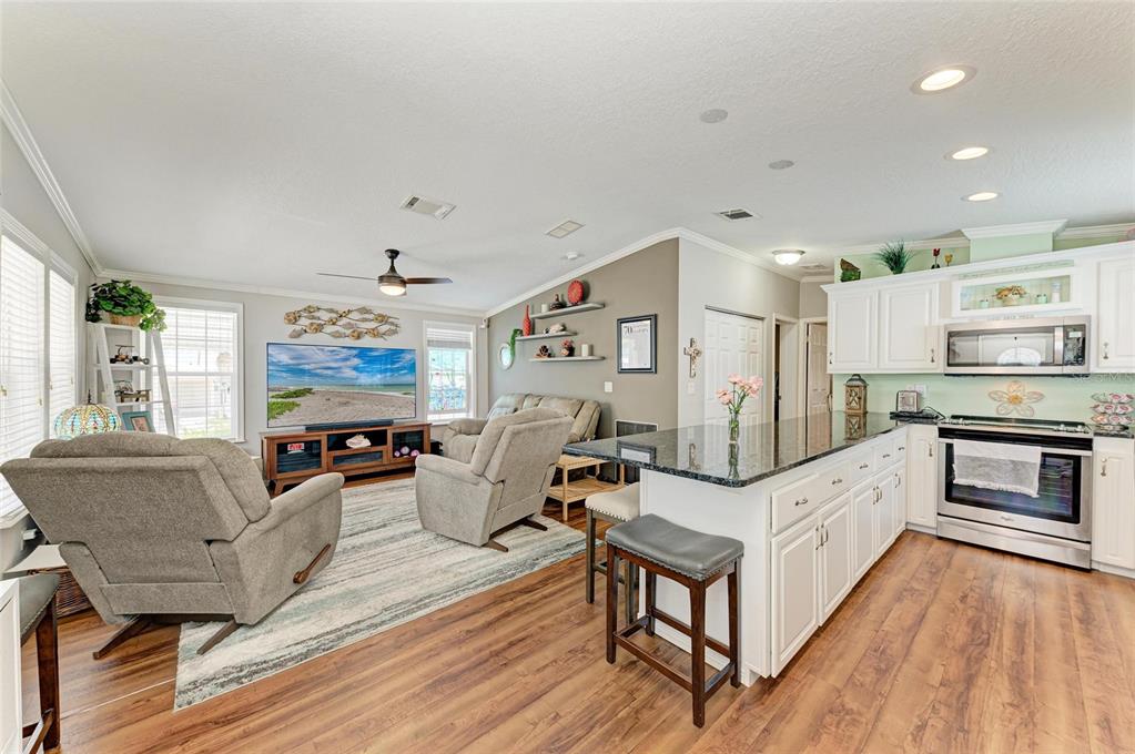 12507 Cortez Road West, Unit 35 Cortez, FL 34215 - Photo 8 of 36 a living room with furniture and a flat screen tv