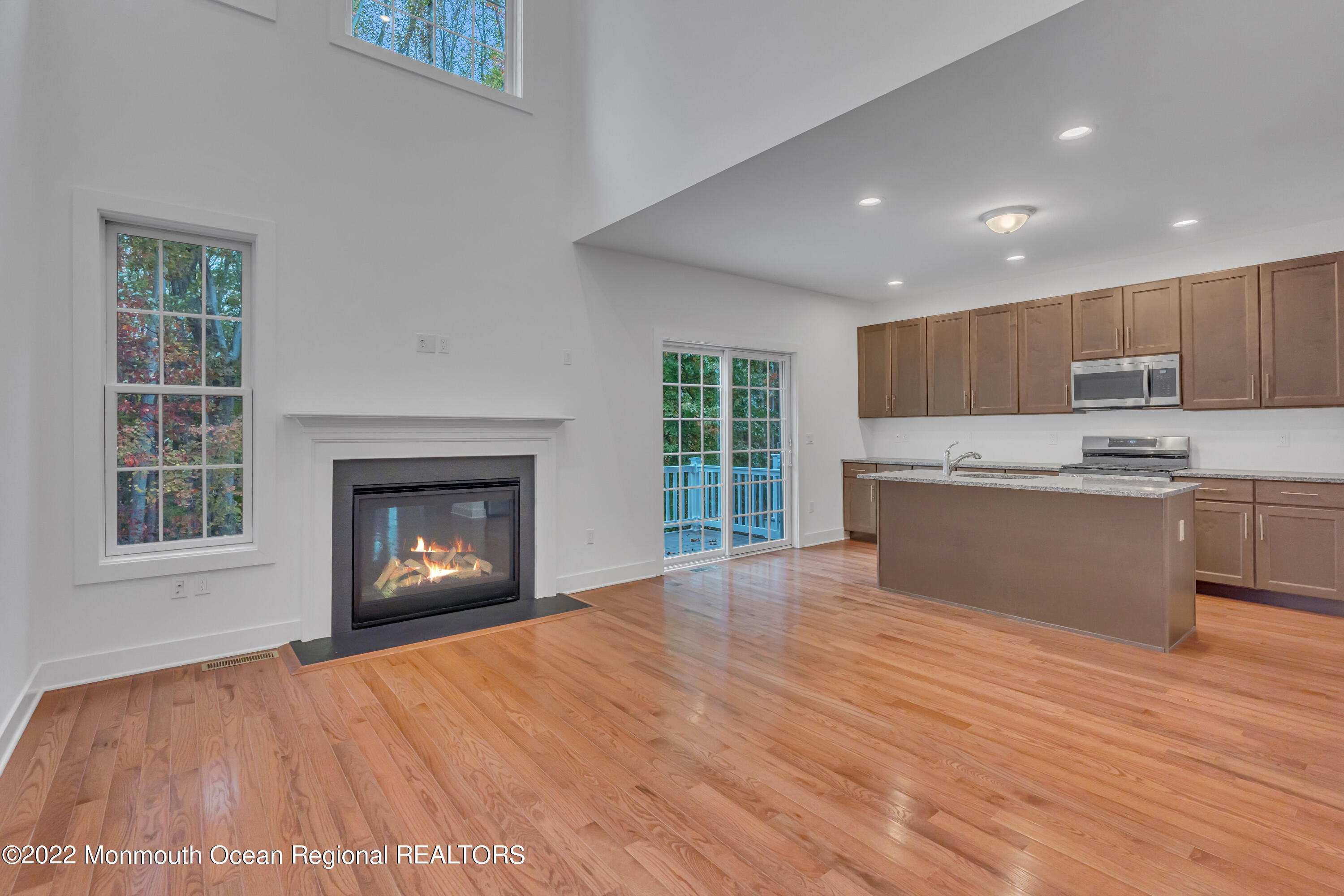 26 Kitchen Avenue Old Bridge, NJ 08857 - Photo 16 of 38 a open kitchen with kitchen island a sink dishwasher a stove and a refrigerator with wooden floor