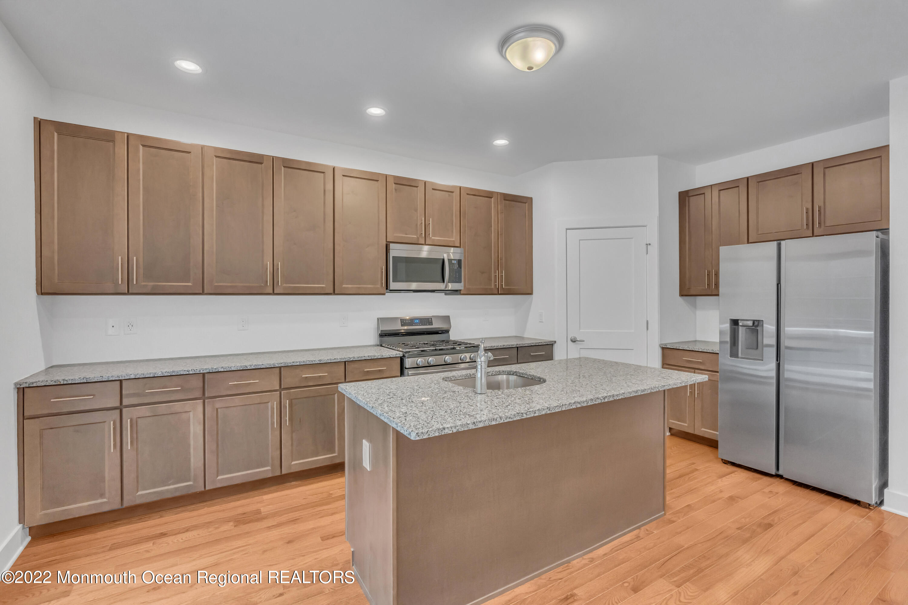 26 Kitchen Avenue Old Bridge, NJ 08857 - Photo 18 of 38 a kitchen with stainless steel appliances granite countertop a sink stove and refrigerator