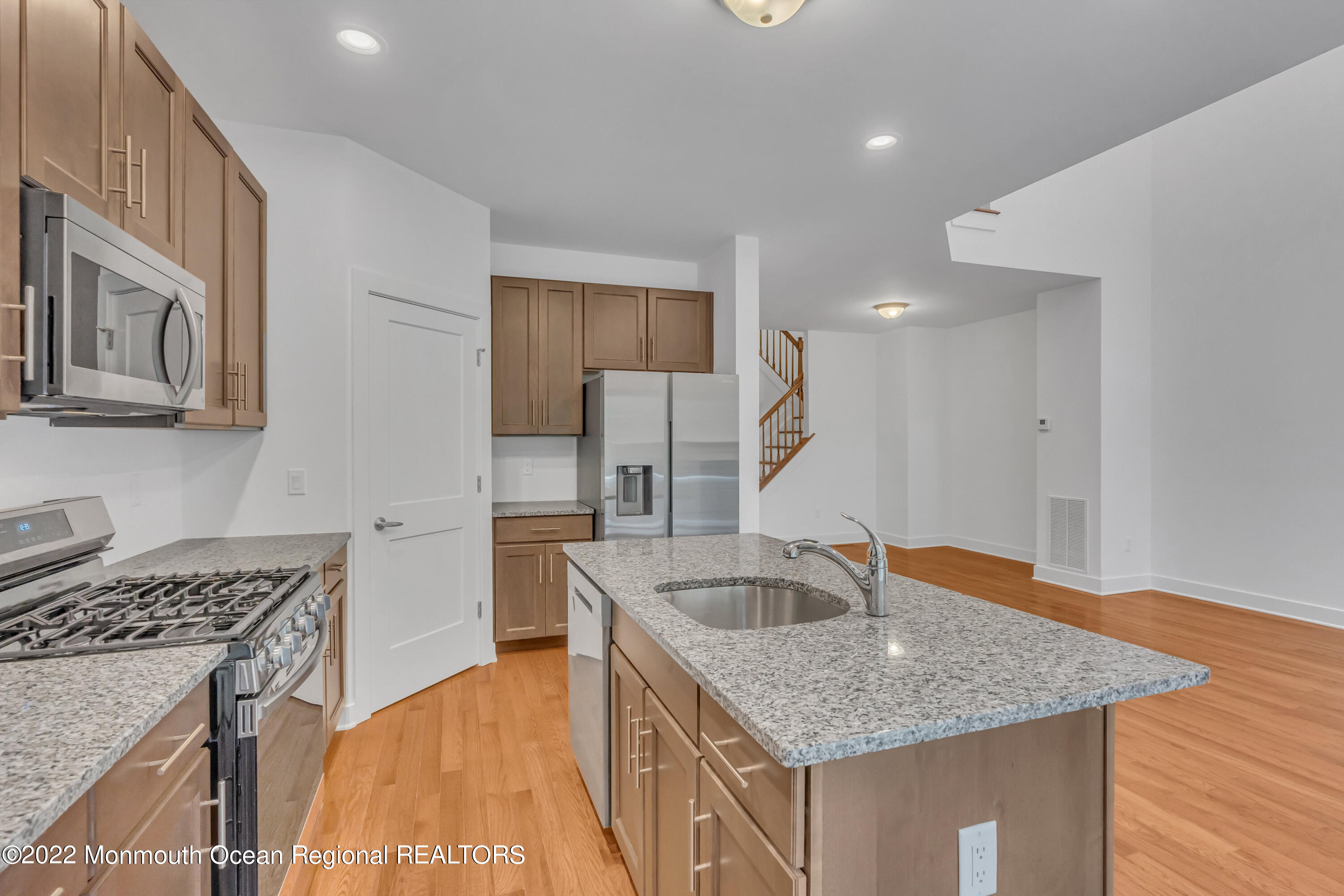 26 Kitchen Avenue Old Bridge, NJ 08857 - Photo 20 of 38 a kitchen with stainless steel appliances granite countertop a sink dishwasher and stove with wooden floor
