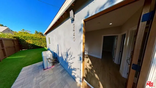 a view of a porch with chairs and backyard