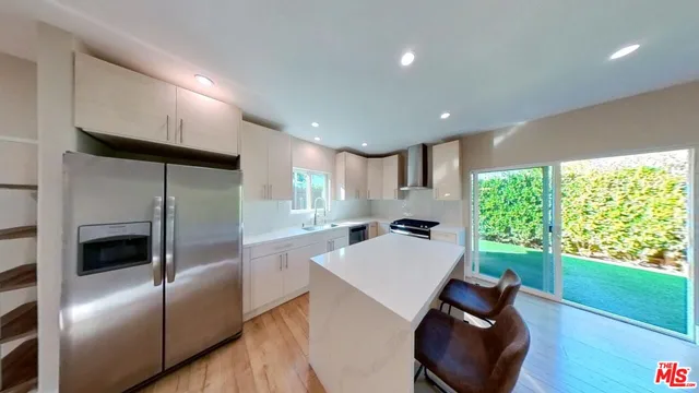 a kitchen with a refrigerator and a table