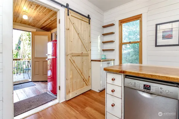 a kitchen with a stove a sink and a window