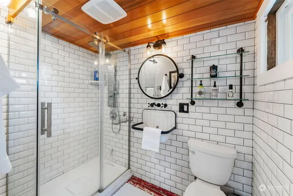 a bathroom with a toilet and a shower