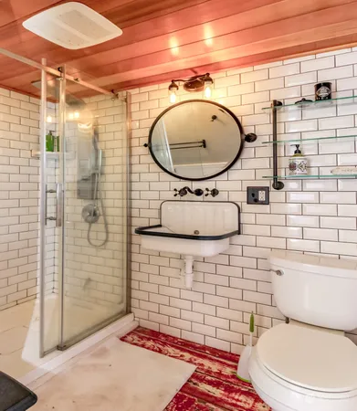 a bathroom with a toilet a sink and shower