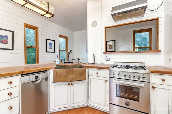 a kitchen with stainless steel appliances granite countertop a stove and a sink