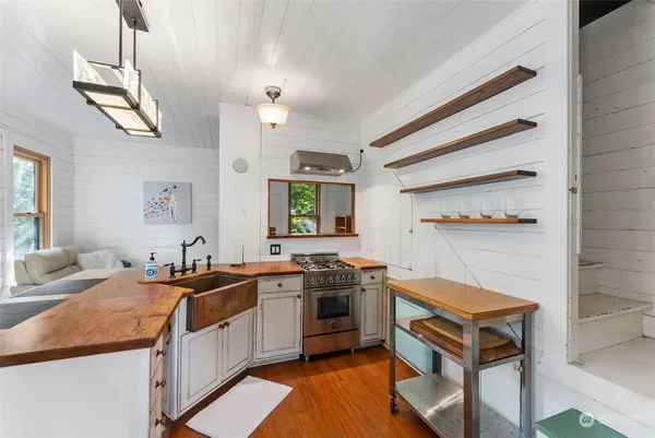 a kitchen with a sink stove and cabinets