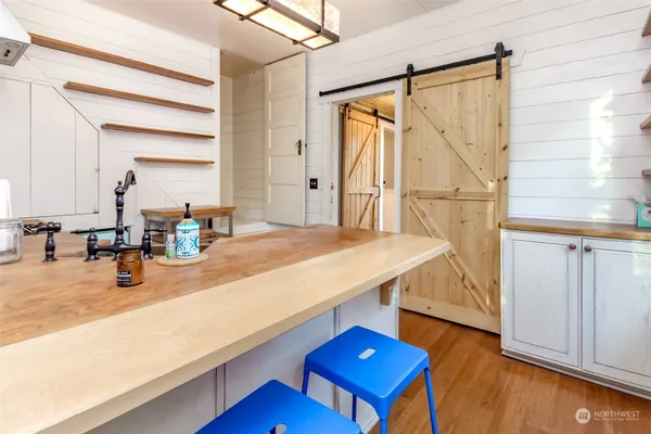 a kitchen with kitchen island a sink stove and wooden floor