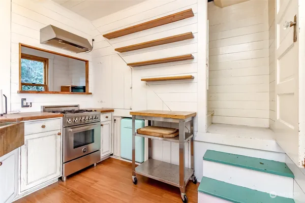 a kitchen with a stove oven and sink