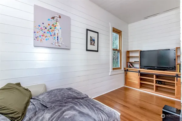 a bedroom with a bed and a flat screen tv