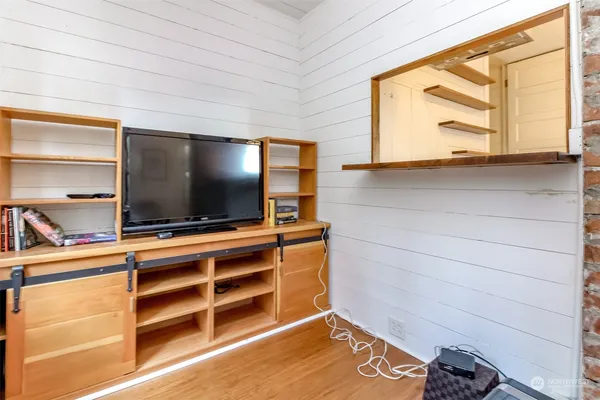 a view of room with wooden floor and a flat screen tv