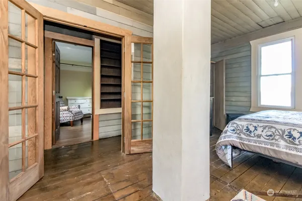 a bedroom with a bed and a window