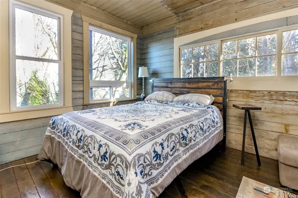 a bed sitting in a bedroom next to a window