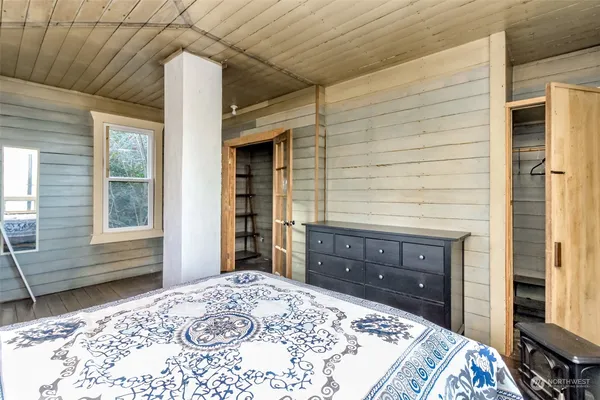 a bedroom with a bed and a dresser