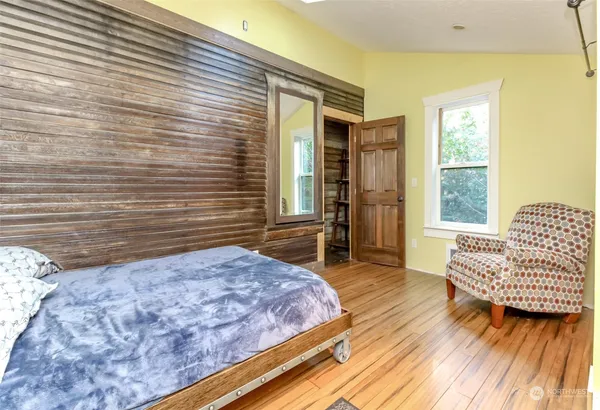 a bedroom with a bed and a couch
