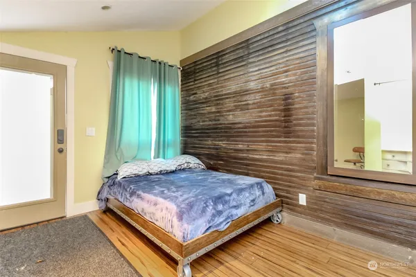 a bedroom with a bed and windows