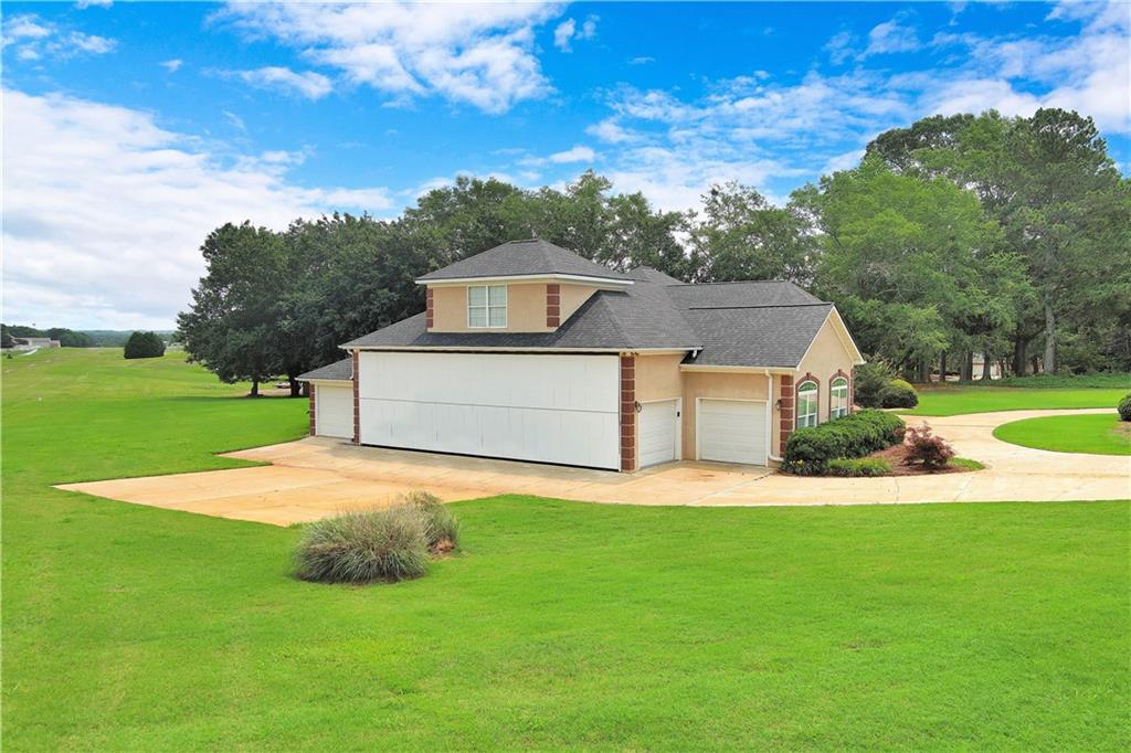 335 Canvasback Trail Locust Grove, GA 30248 - Photo 12 of 91 a front view of a house with a yard and garage