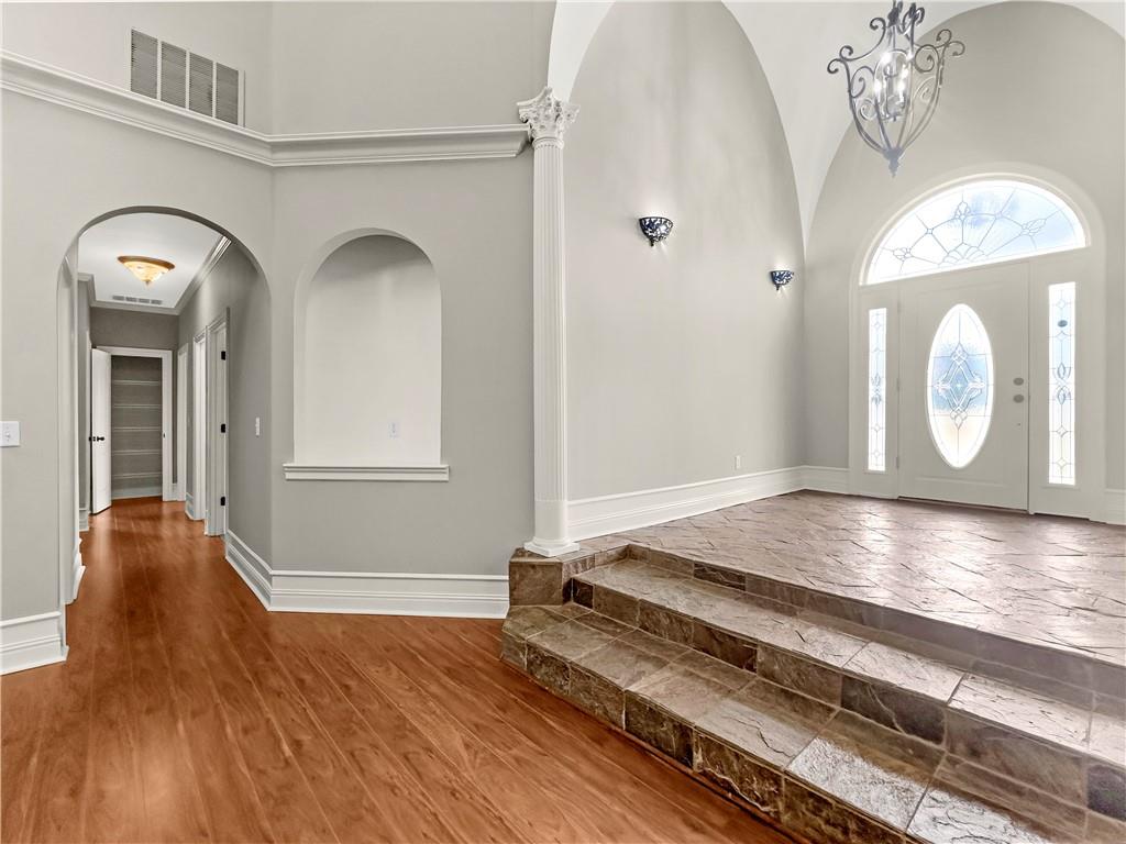 335 Canvasback Trail Locust Grove, GA 30248 - Photo 17 of 91 a view of a livingroom with wooden floor and a chandelier