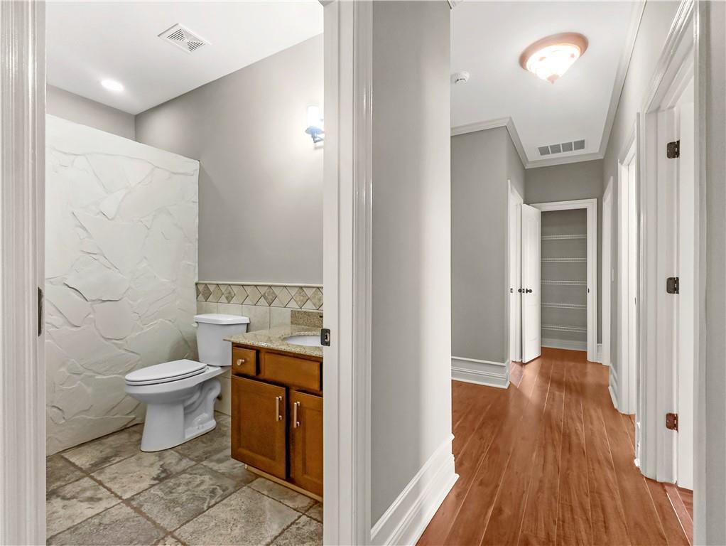 335 Canvasback Trail Locust Grove, GA 30248 - Photo 21 of 91 a bathroom with a toilet sink and a mirror