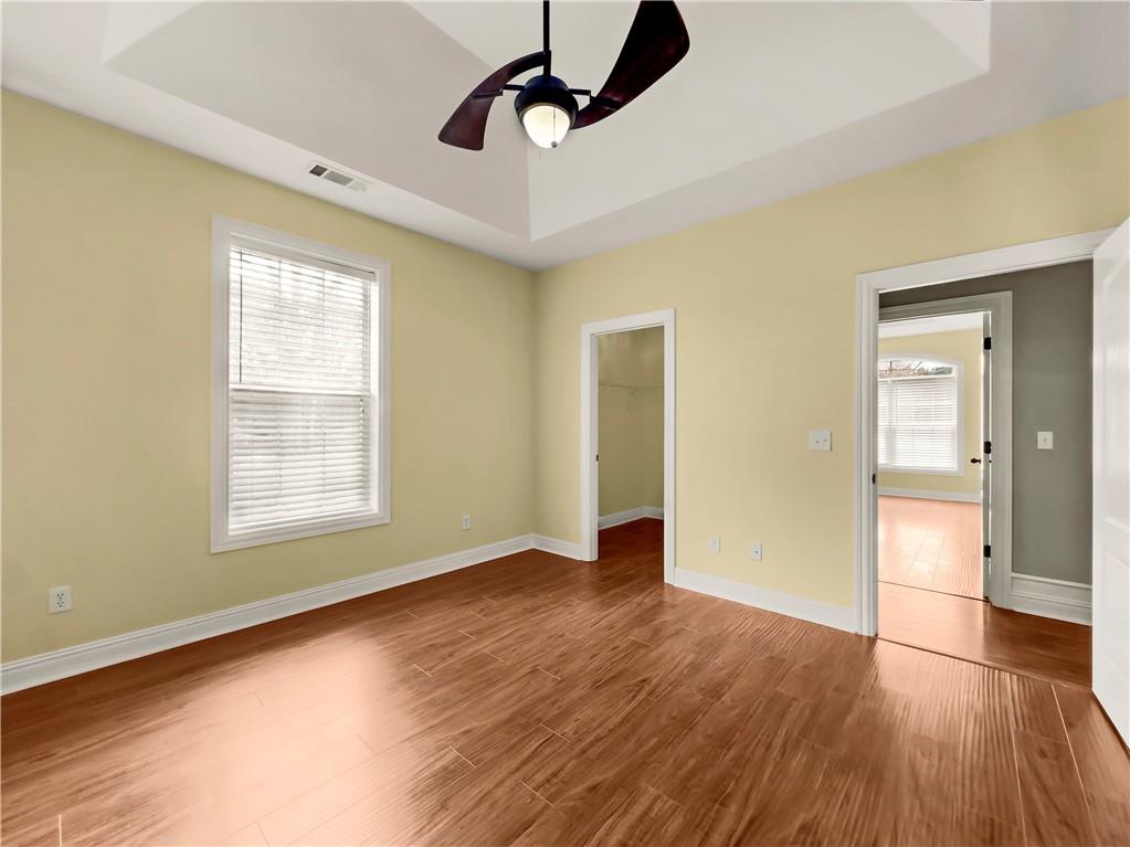 335 Canvasback Trail Locust Grove, GA 30248 - Photo 32 of 91 a view of an empty room with window and wooden floor