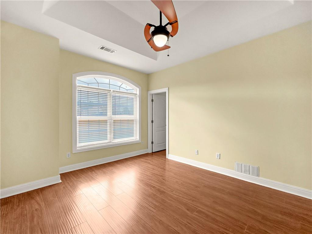 335 Canvasback Trail Locust Grove, GA 30248 - Photo 35 of 91 a view of an empty room with wooden floor and a window