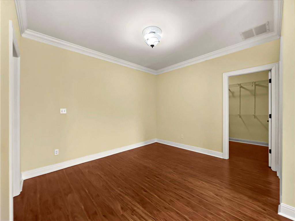 335 Canvasback Trail Locust Grove, GA 30248 - Photo 39 of 91 a view of an empty room with wooden floor and a window
