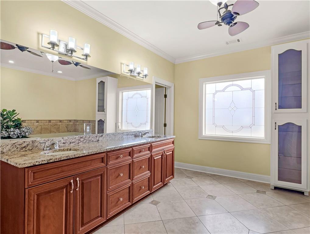 335 Canvasback Trail Locust Grove, GA 30248 - Photo 44 of 91 a bathroom with a granite countertop double vanity sink a window and a mirror