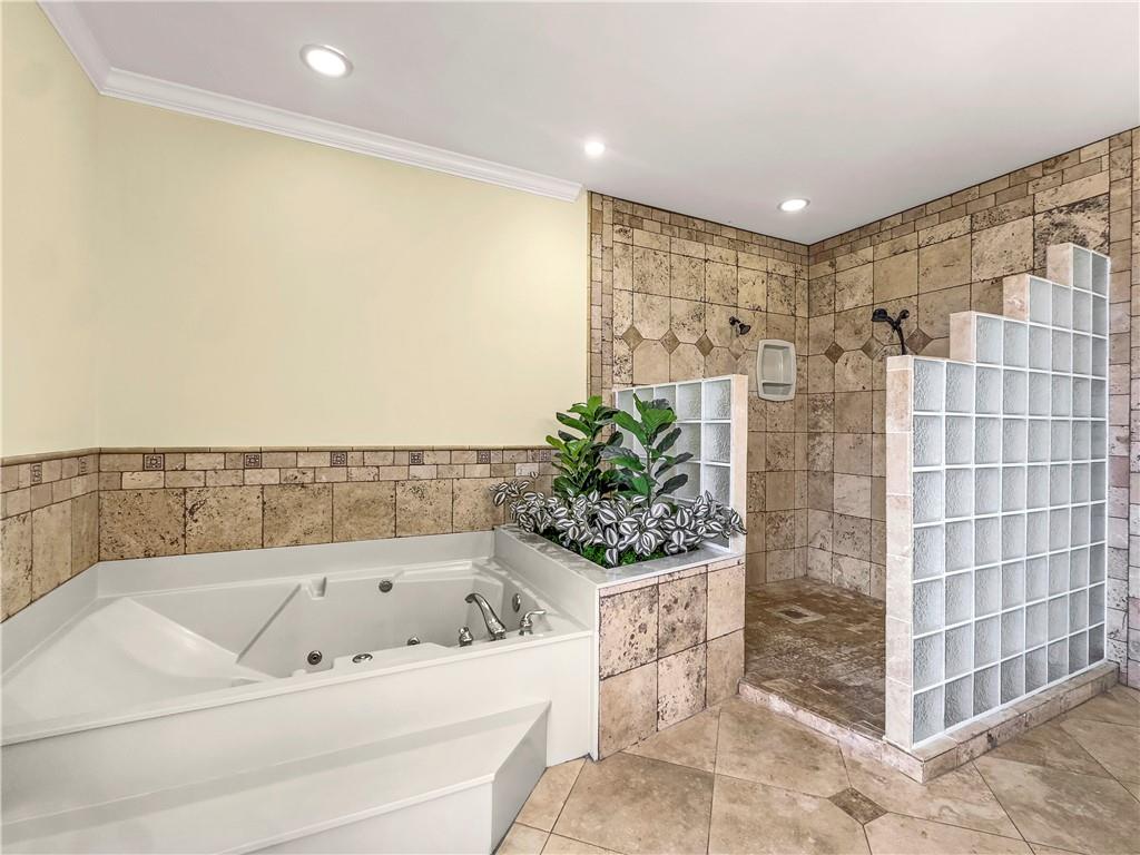 335 Canvasback Trail Locust Grove, GA 30248 - Photo 45 of 91 a bathroom with a bathtub and a shower