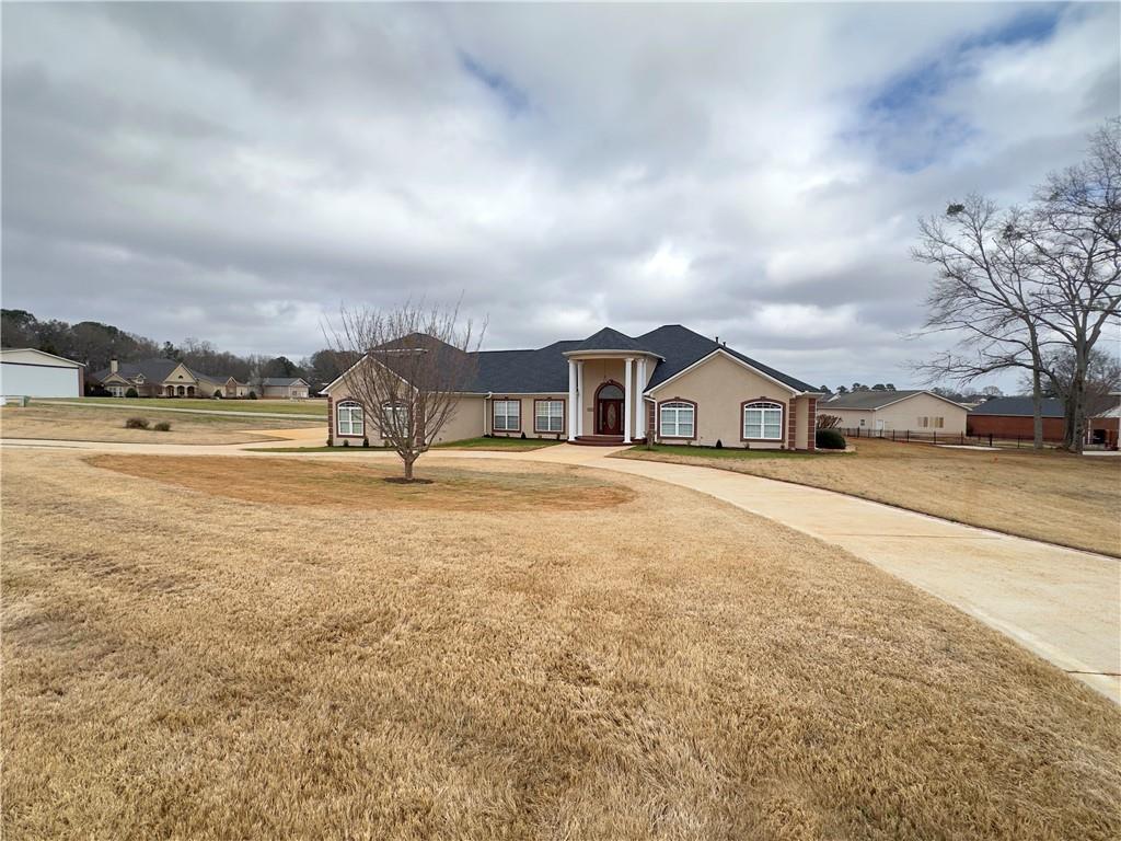 335 Canvasback Trail Locust Grove, GA 30248 - Photo 52 of 91 a view of a house with a yard and sitting area